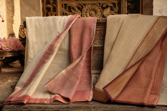 A handloom saree and a powerloom saree displayed side by side on an earthy Indian surface, showing differences in weave texture, borders, and reverse sides.